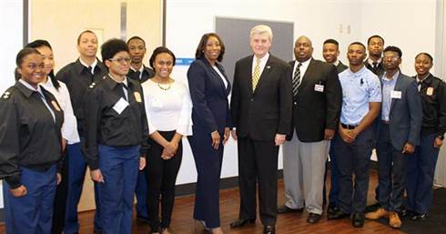  Standing with select cadet leaders and instructors from JPS JROTC cadets are (center, from left) Dr