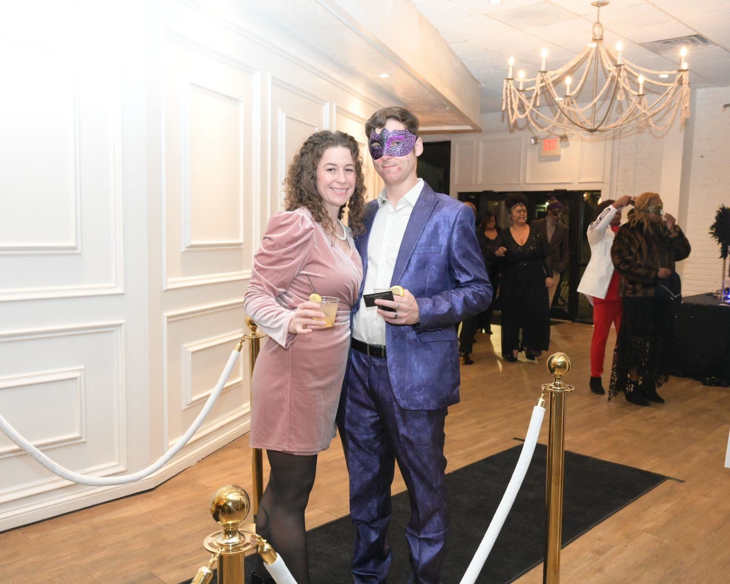 Couple smiling at black carpet entrance