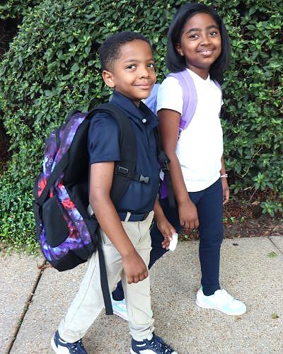 Boy in navy and khaki, girl in white, navy