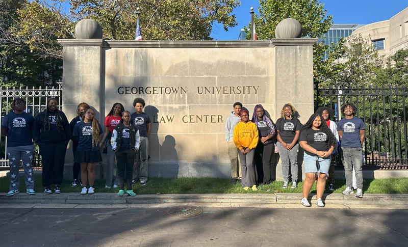 GCP scholars in front of Georgetown University name stone