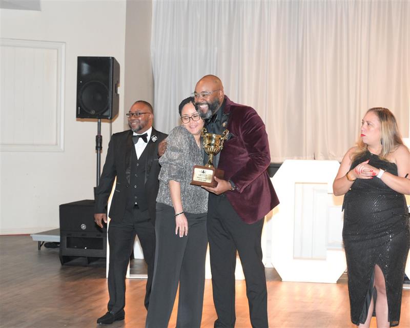 Woman presents man with award